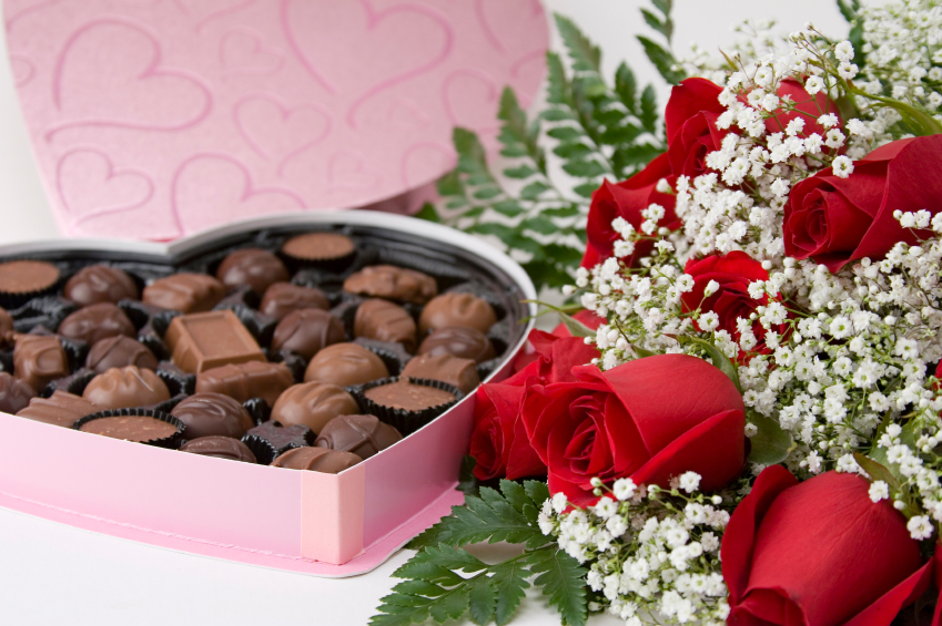 Picture of a dozen Red Roses on white background with Heart Shaped Box of Chocolates